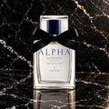 ALPHA Legacy Edition 50 mL eau de parfum with a black ribbon on black marble